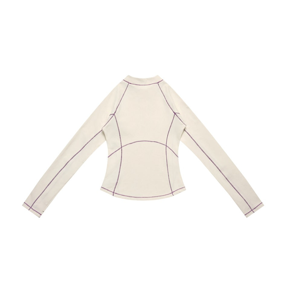 Back view of an ivory long-sleeve top with purple contrast seam stitching, laid flat.
