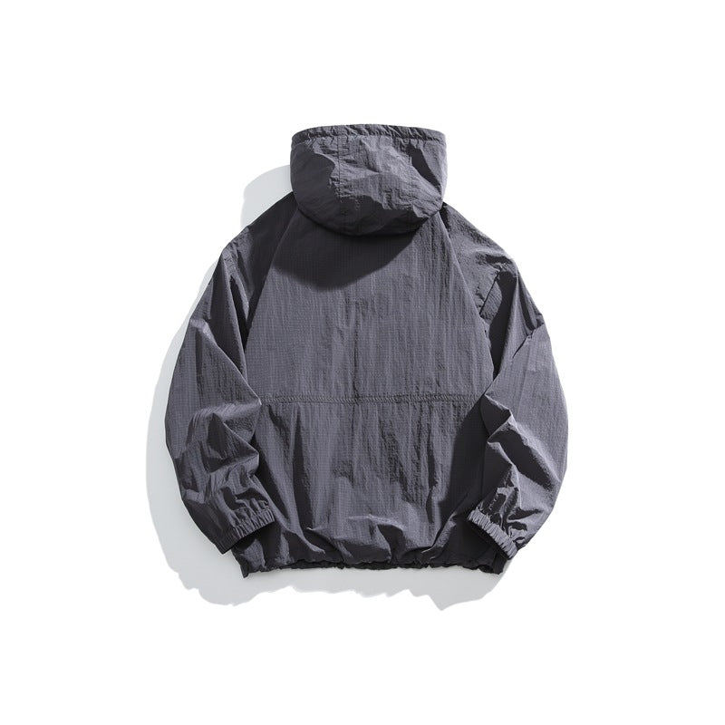 Back view of a dark slate-gray hooded jacket with elastic cuffs and hem, shown flat against a white background.