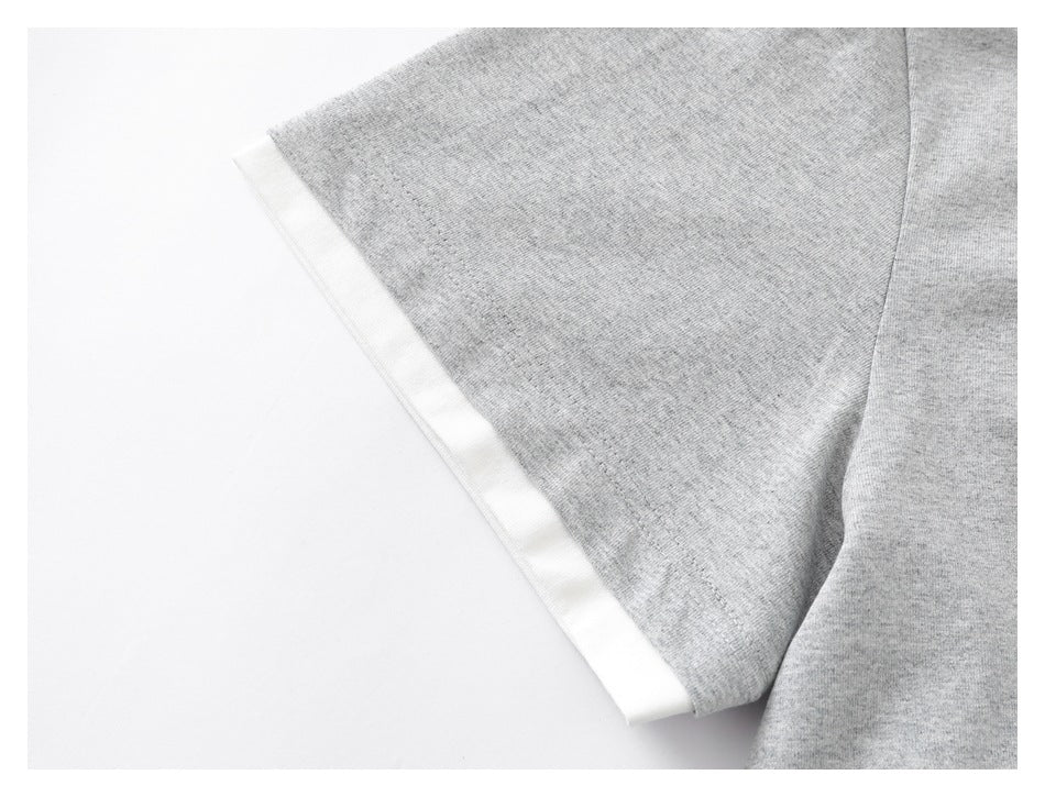 Close-up of a heather-gray T-shirt sleeve with a white contrast band at the cuff.