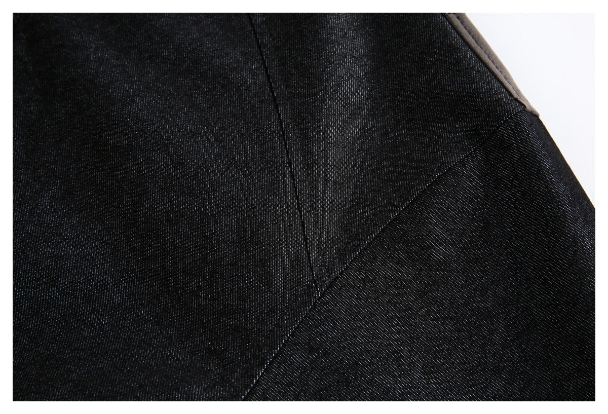 Close-up of the jacket's dark fabric and angled seam detailing.