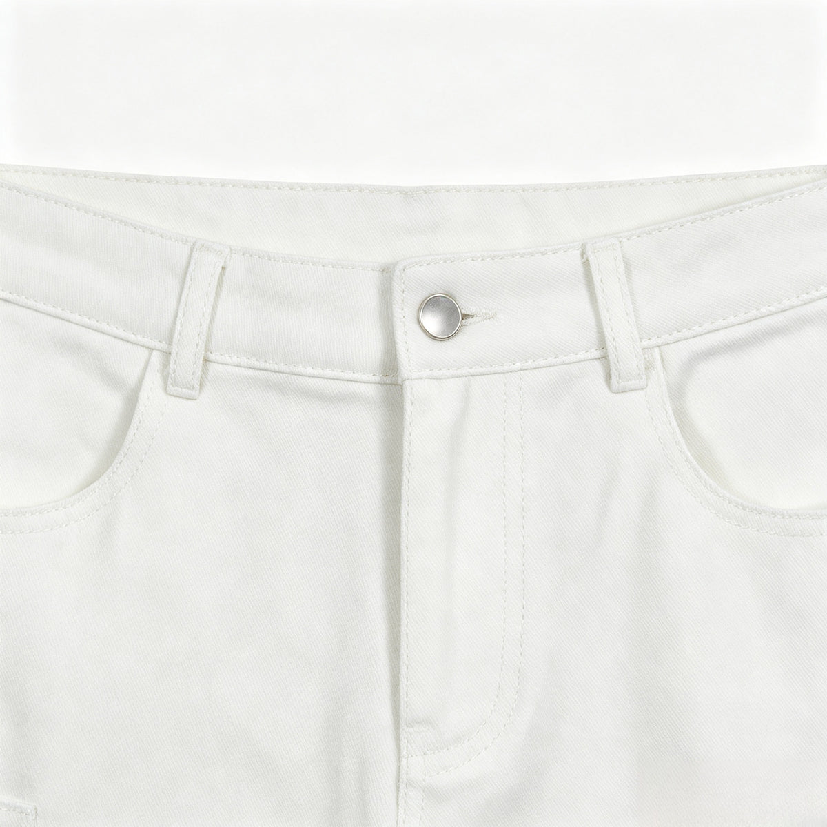 Close-up of white pants showing the front waistband, silver button, belt loops, fly stitching, and curved pockets.