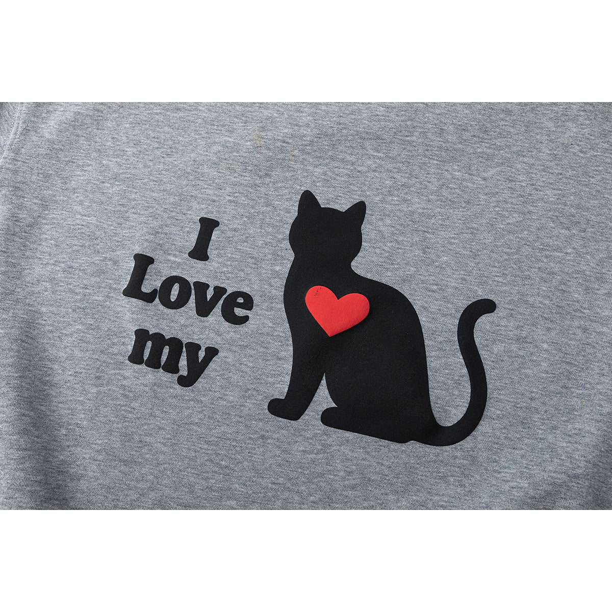 Close-up of a gray sweatshirt graphic with a black cat, red heart, and the words “I Love my.”