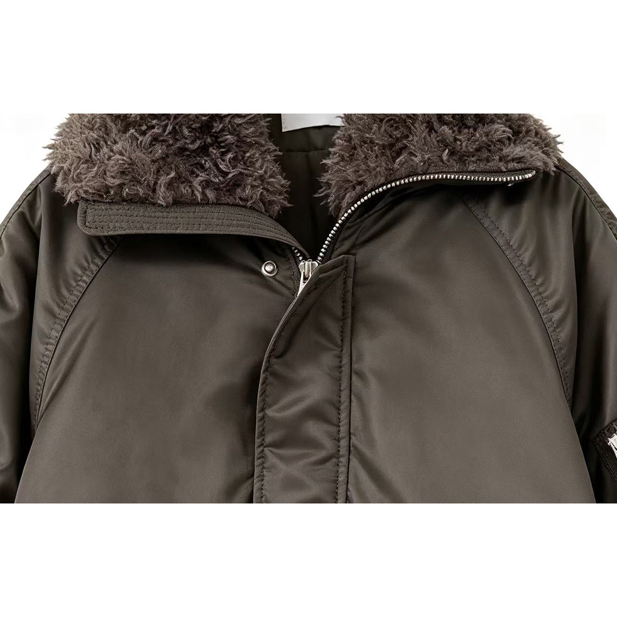 Close-up of the dark olive jacket's plush gray collar, front zipper, snap, and stitched panels.