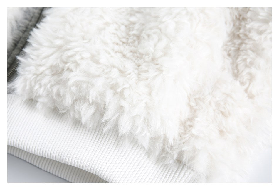 Close-up of the jacket's white fluffy fabric and wide ribbed hem.