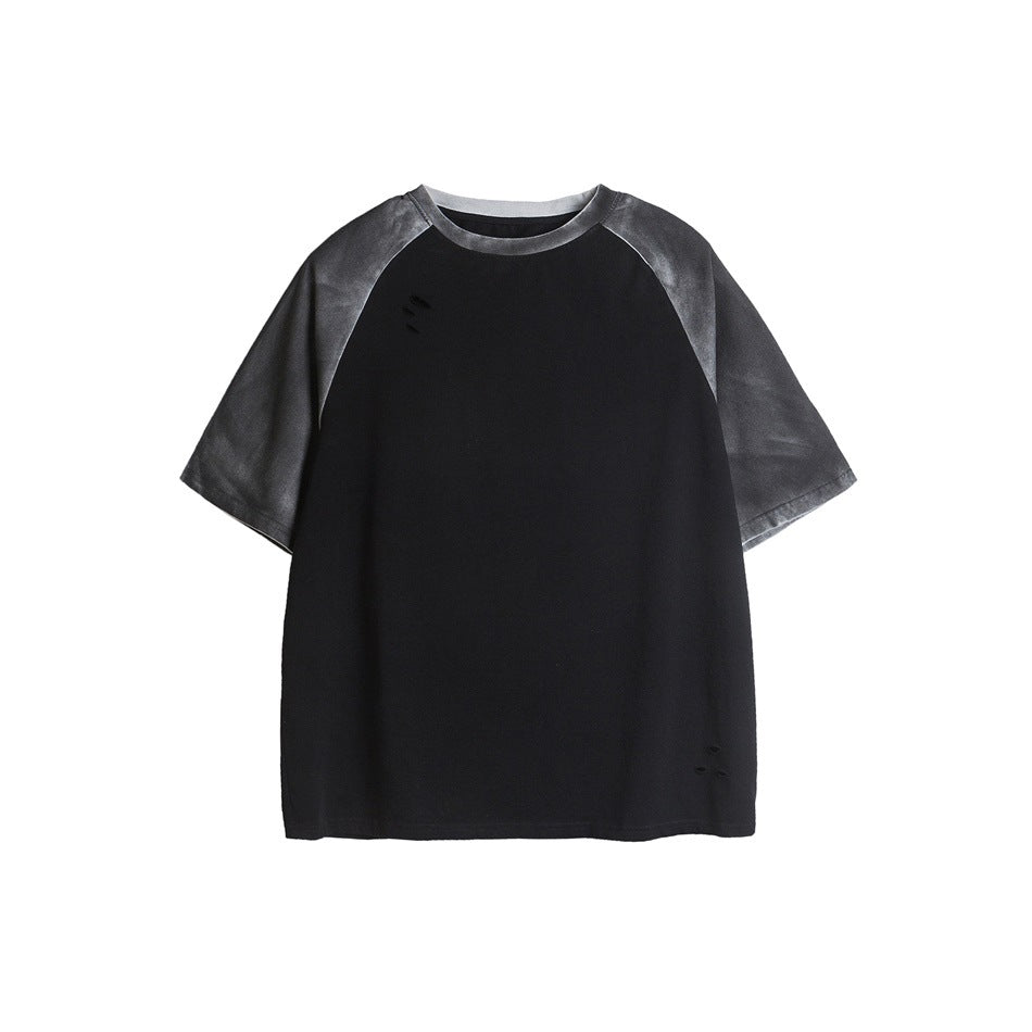 Black raglan T-shirt with washed gray sleeves and collar and small distressed holes on the front, flat lay