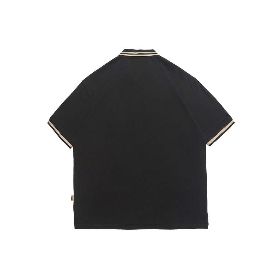 Back view of a black short-sleeve polo shirt with beige-and-black striped collar and sleeve trim.