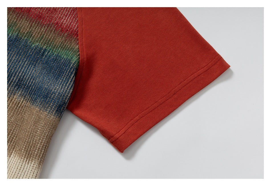 Close-up of a rust-red sleeve hem beside multicolored brown, blue, and cream knit fabric.