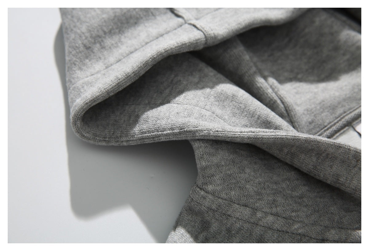 Close-up of the light gray hoodie's hood edge, inner fabric, and stitching.