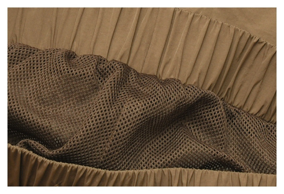 Close-up of the gathered tan waistband and dark mesh lining inside the garment.