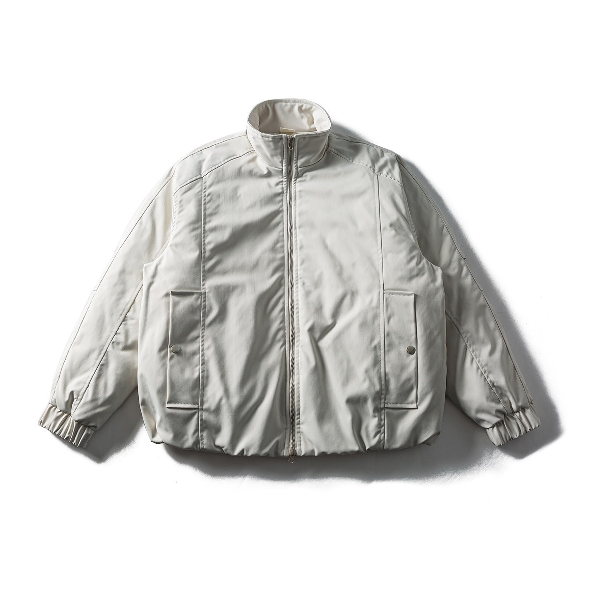Apricot stand-collar zip jacket laid flat, with front patch pockets with snaps, elastic cuffs and a gathered hem