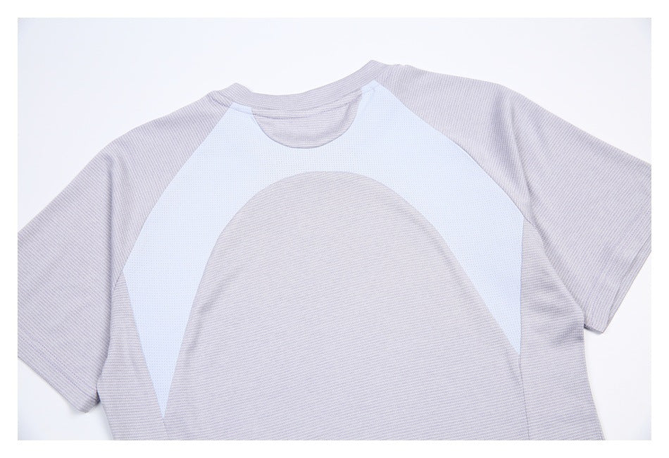 Flat view of a pale gray-lavender short-sleeve shirt back with a white curved mesh panel and rounded gray insert.