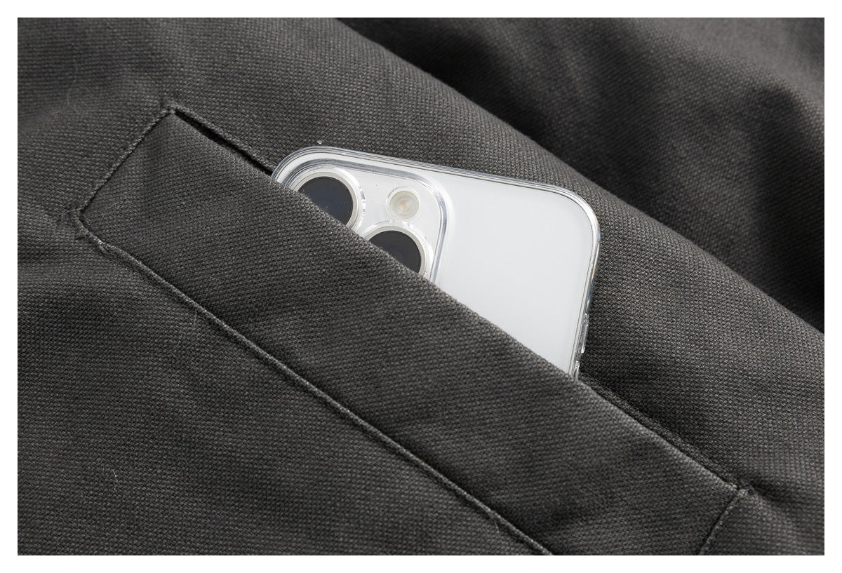 A white smartphone tucked into a narrow pocket in dark jacket fabric.