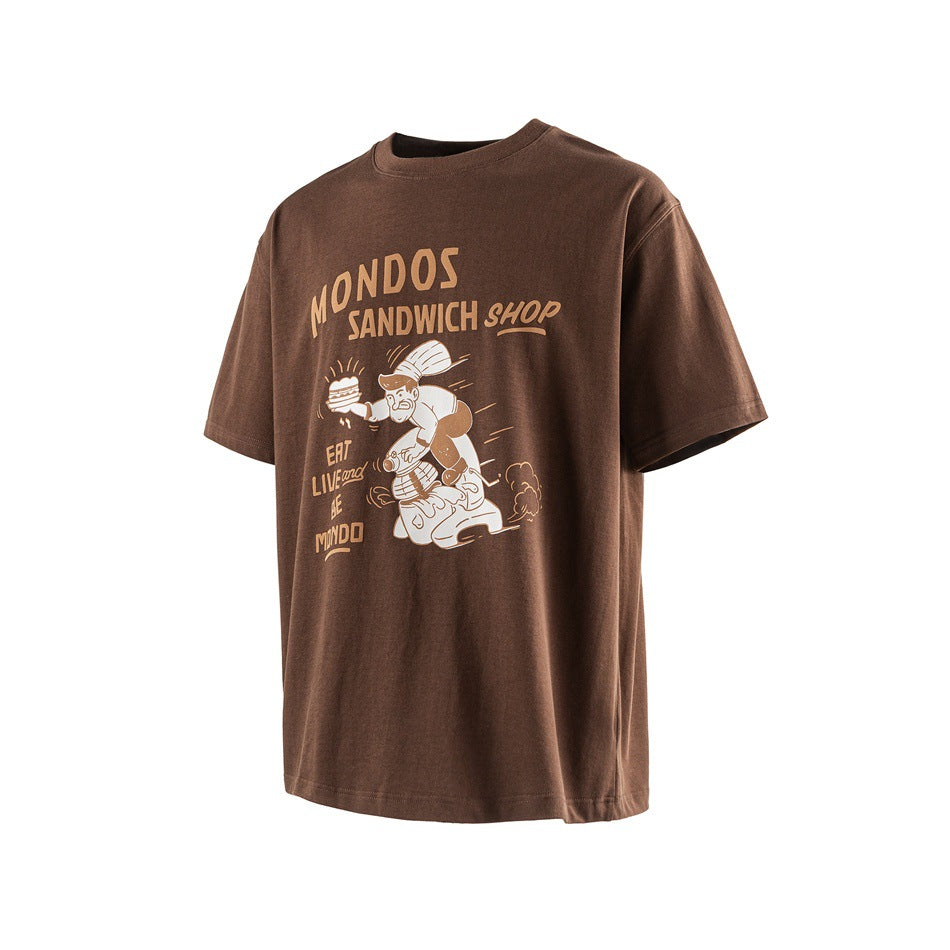 Brown short-sleeve T-shirt with tan and cream MONDOS SANDWICH SHOP chef-on-scooter print, angled front view