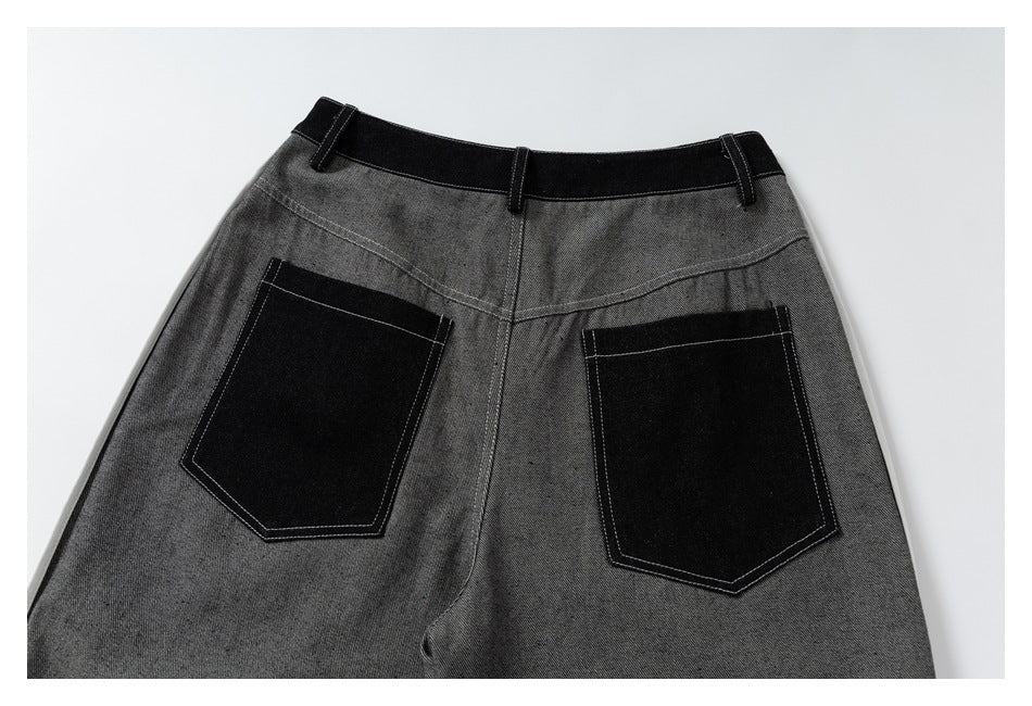 Back view of gray trousers with a black waistband and two large black patch pockets.