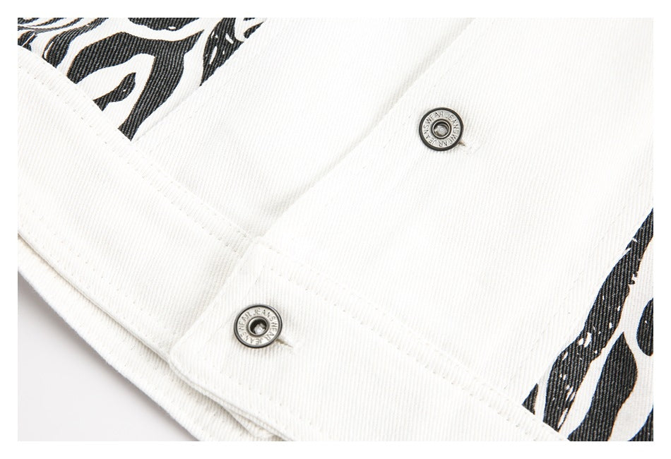 Close-up of white denim seams, two metal snaps and part of a black zebra-pattern panel.