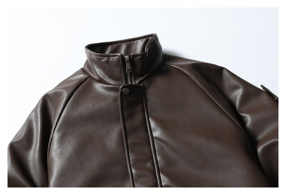 Close-up of a dark brown jacket's stand collar, zipper, snap-fastened placket, and upper front.