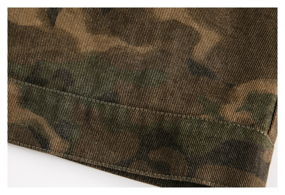 Close-up of stitched seams along the hem of a brown and olive camouflage garment.