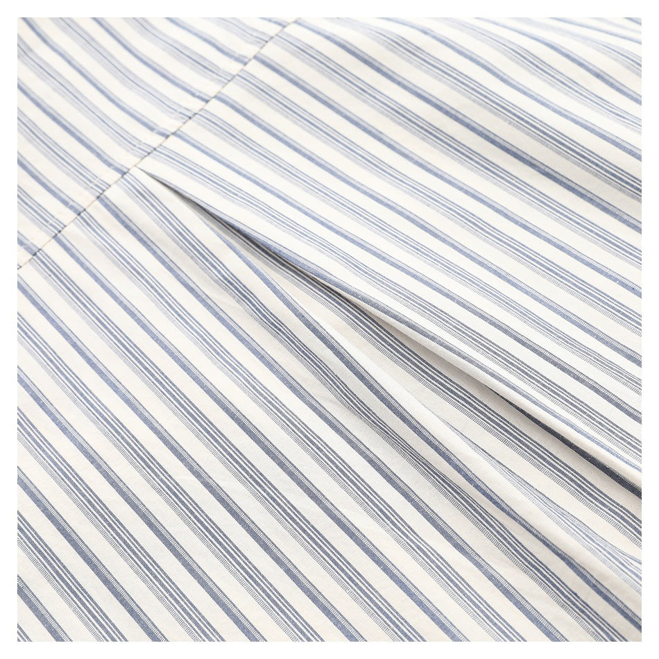 Close-up of the striped shirt fabric showing a folded seam and draped folds.