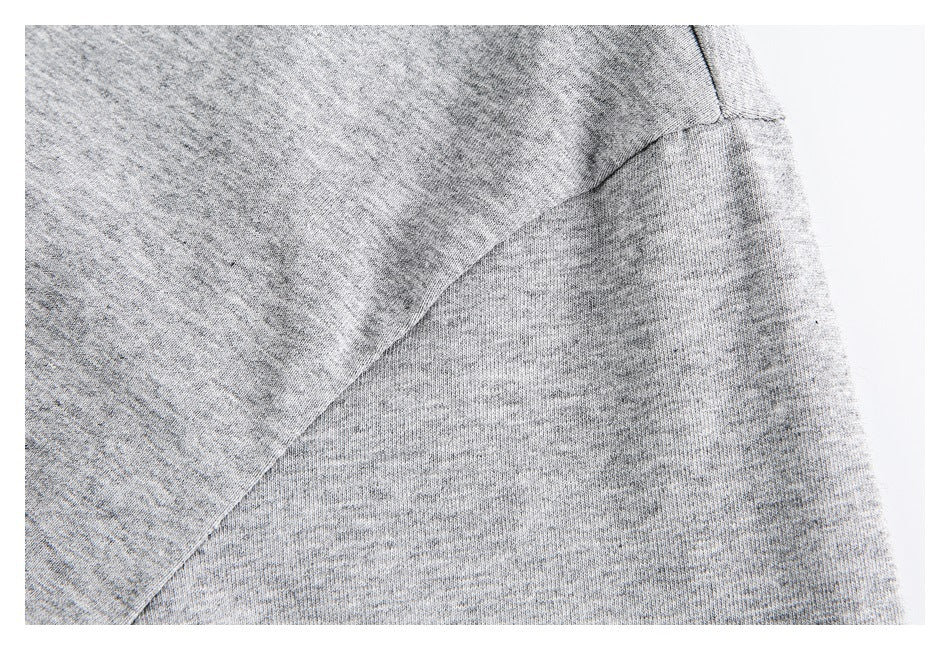 Close-up of a heather gray shirt's curved sleeve seam and fabric.