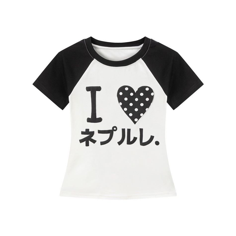 White cropped raglan tee with black sleeves and neckband, polka-dot heart and katakana print on the front
