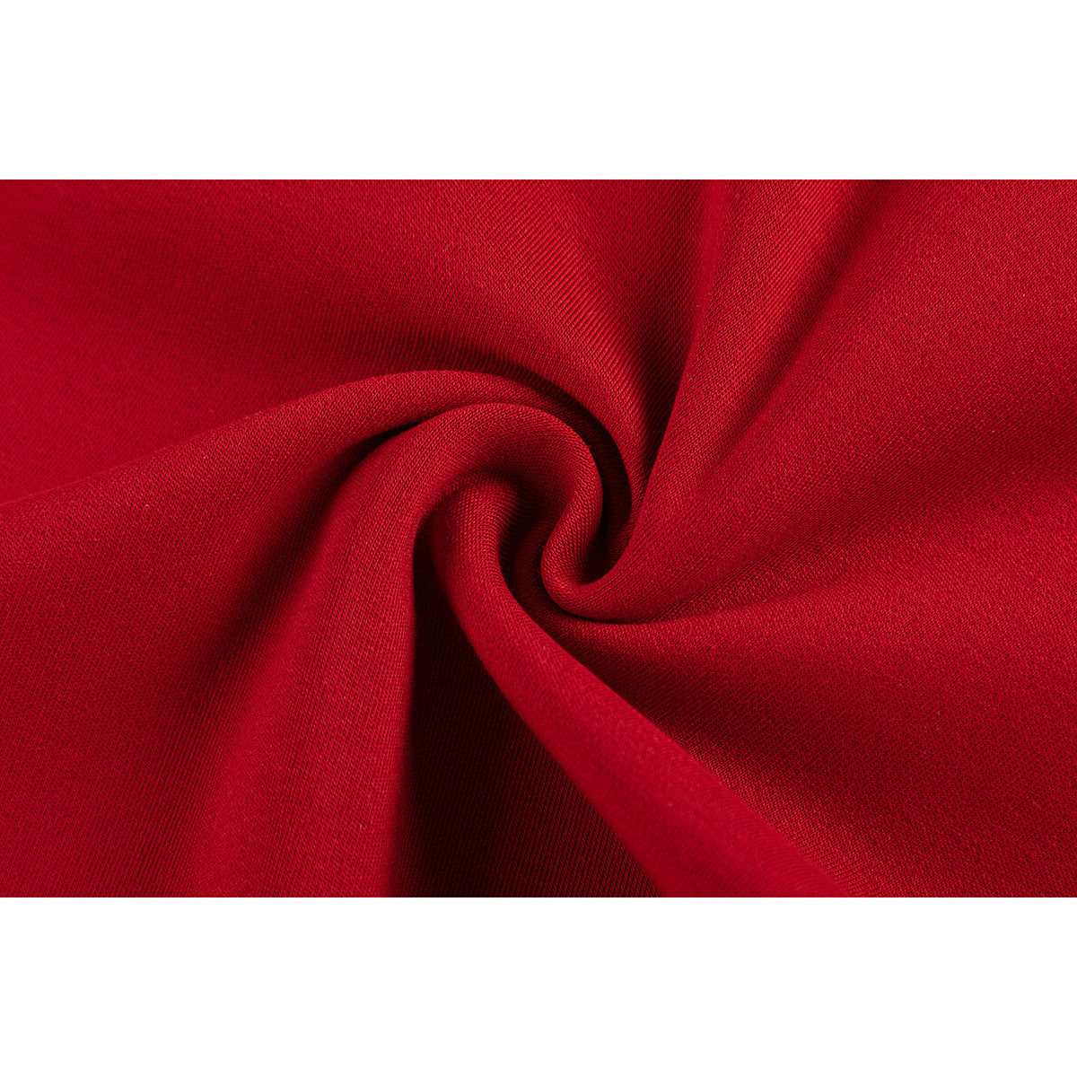 Extreme close-up of red jersey fabric gathered into a fold, showing its textured surface.