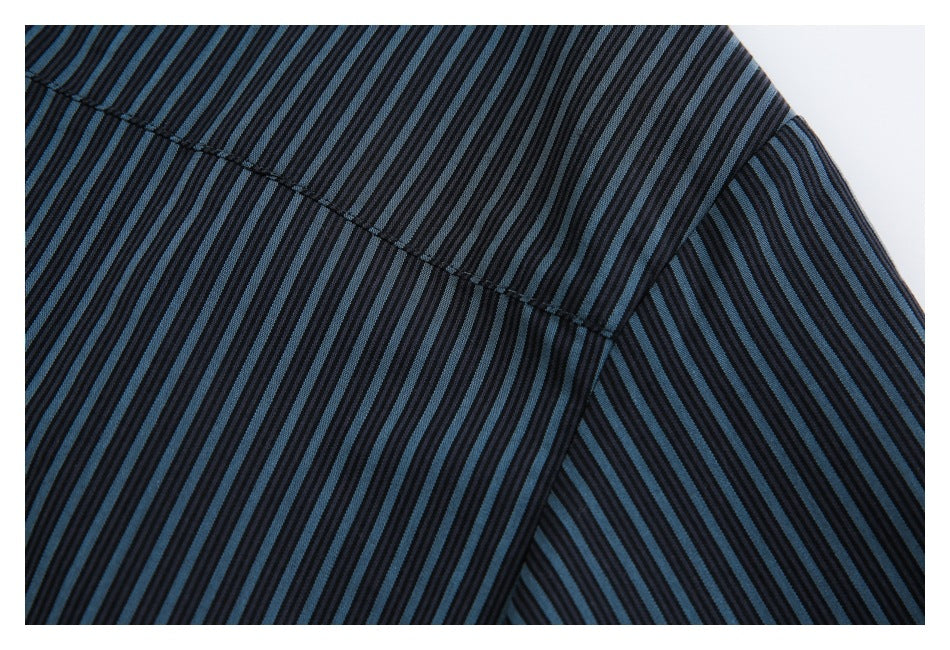 Close-up of dark blue-and-black striped fabric showing intersecting seams.