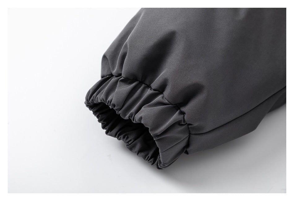 Close-up of an elasticized cuff on a dark gray jacket sleeve.