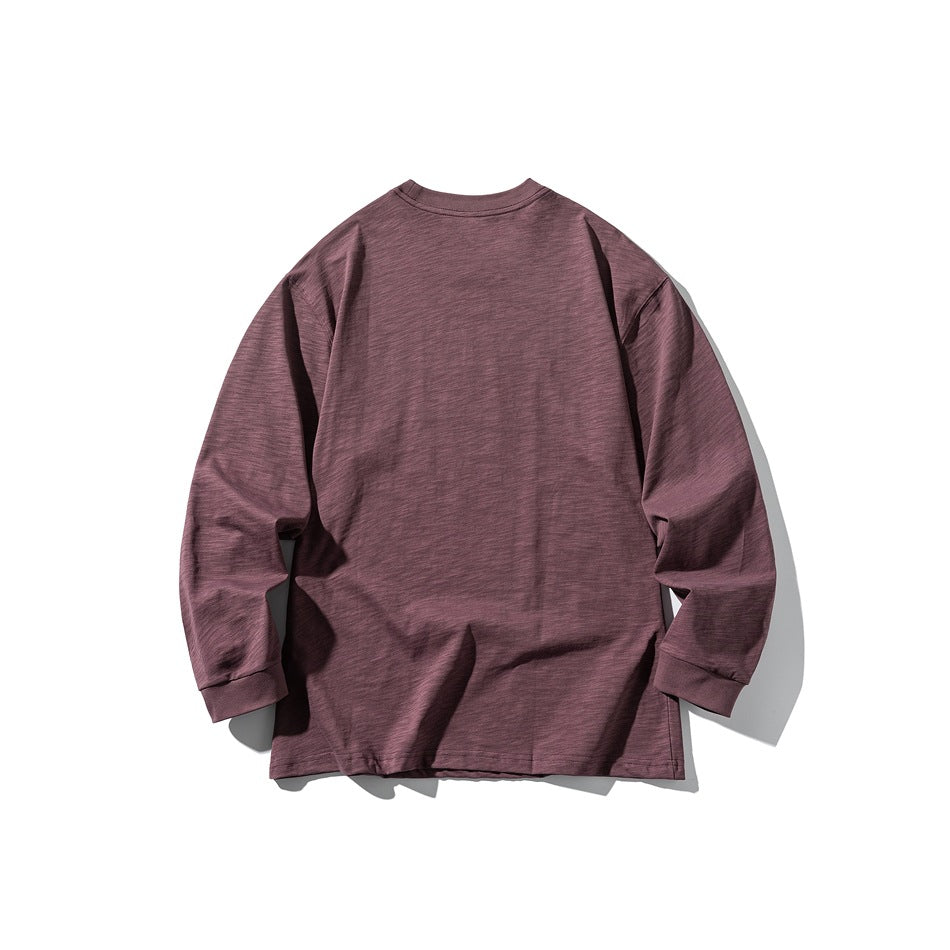Back view of a plain dark mauve long-sleeve crewneck shirt laid flat on a white background.