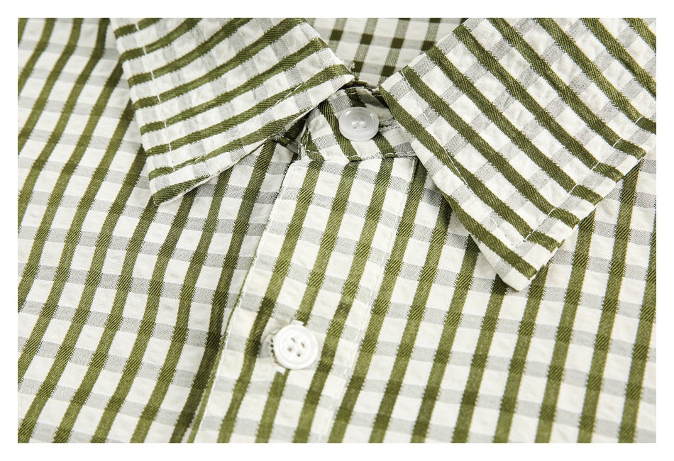 Close-up of an olive-and-white checked shirt collar, placket, and white buttons.