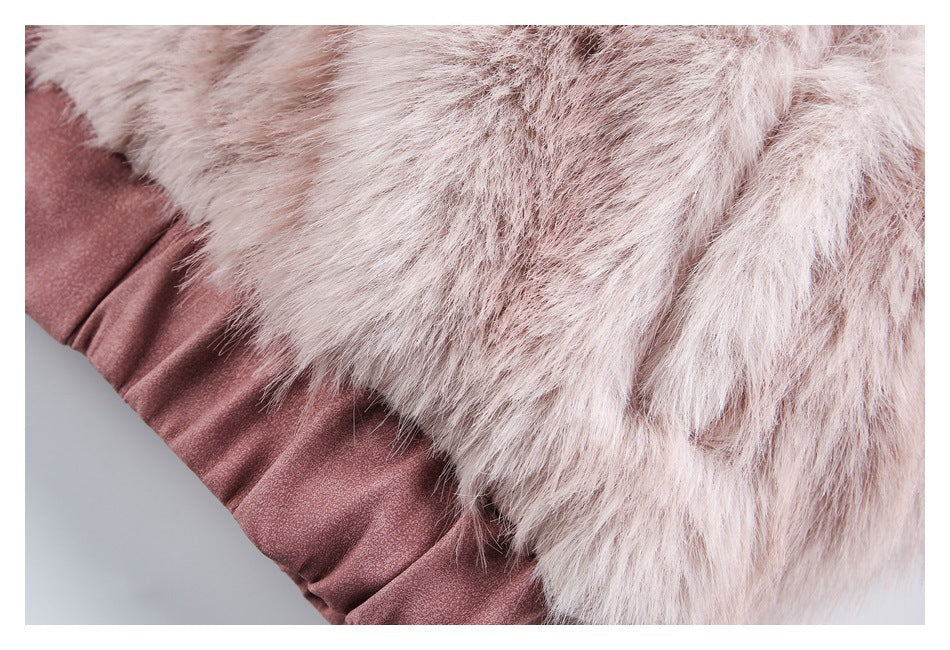 Close-up of pale pink faux fur overlapping gathered rose-pink fabric along the jacket edge.