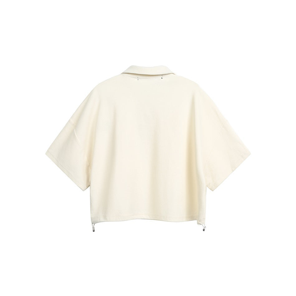 Back view of an ivory short-sleeve collared top with a relaxed cut and adjustable drawcord hem.