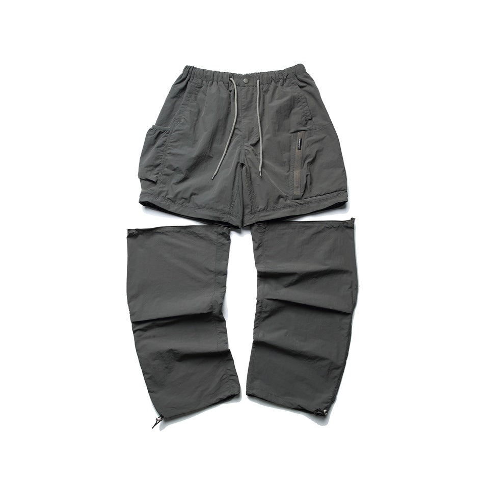 Gray convertible pants laid flat, with the upper shorts section above two detached-looking leg panels.