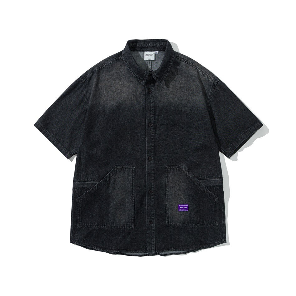 Black washed denim short-sleeve button-up shirt with two large angled front pockets and a purple label