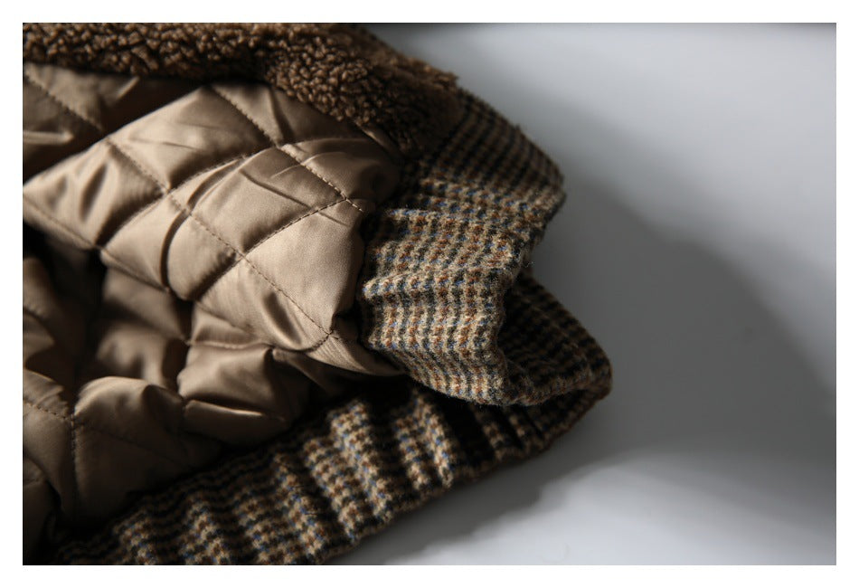 Close-up of the coat's tan quilted lining and checked outer fabric along an edge.