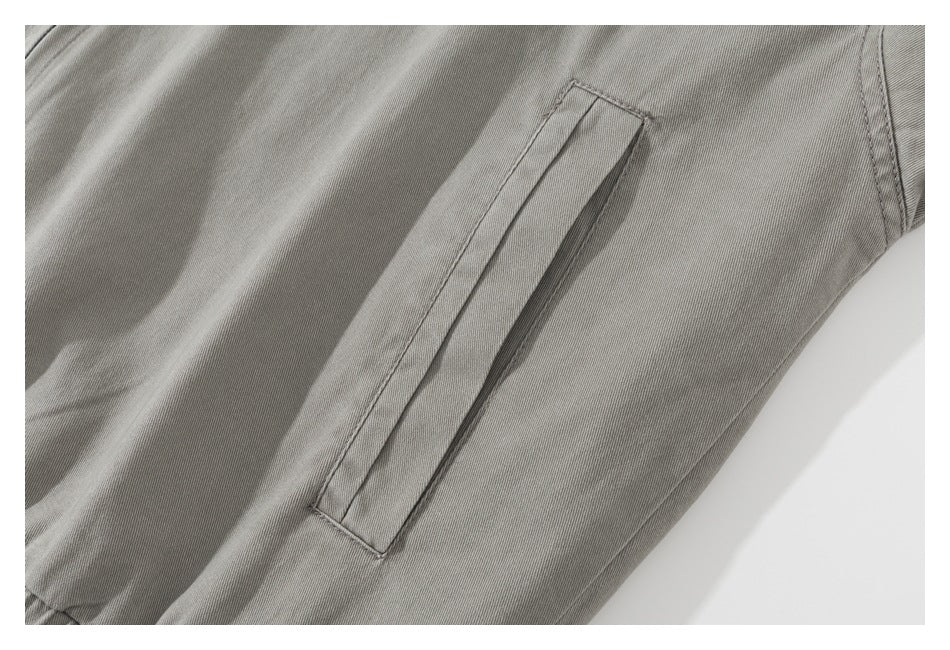 Close-up of a narrow welt pocket on the gray jacket.