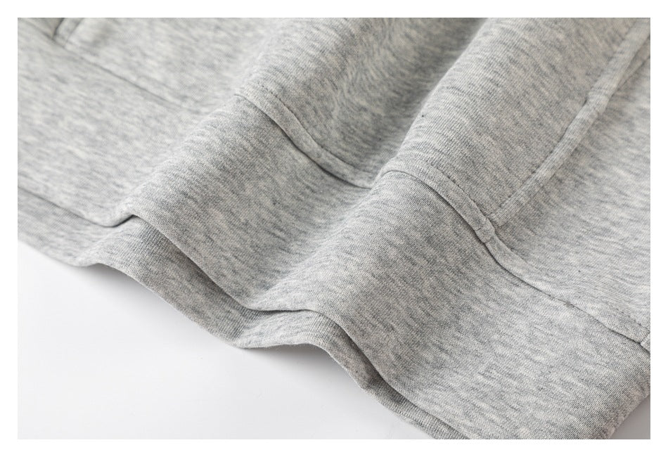 Close-up of a seam and stitched hem on the gray marled garment.