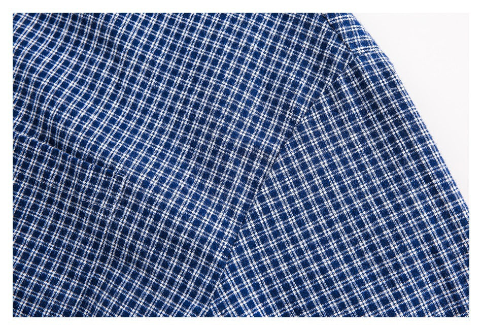 Close-up of navy and white checked fabric with overlapping folds.