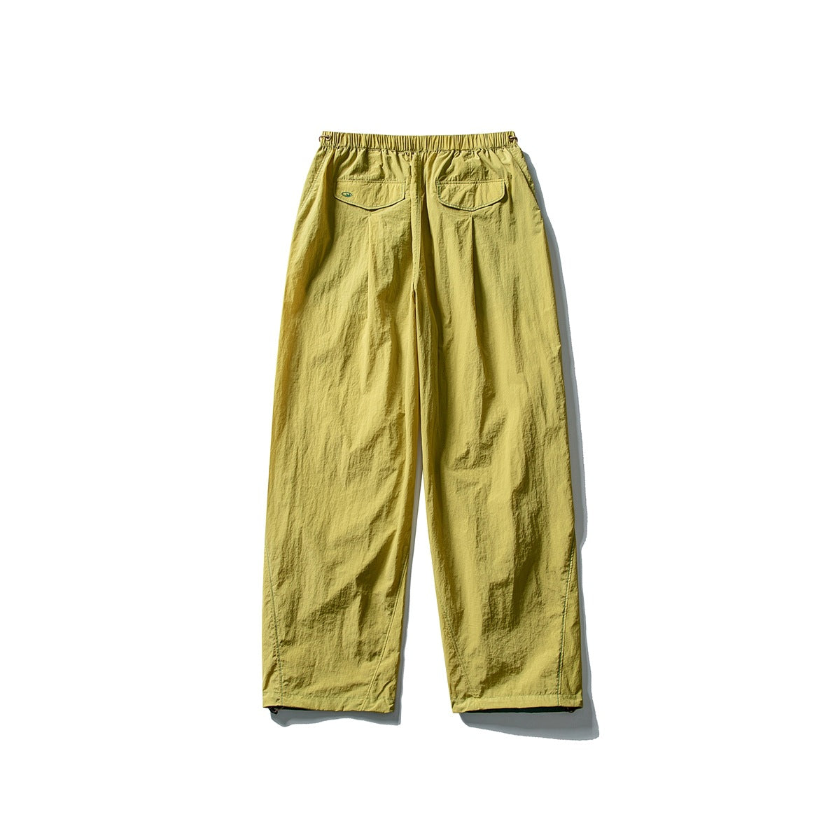 Mustard yellow wide-leg pants with an elastic waist and two flap back pockets, shown from behind.
