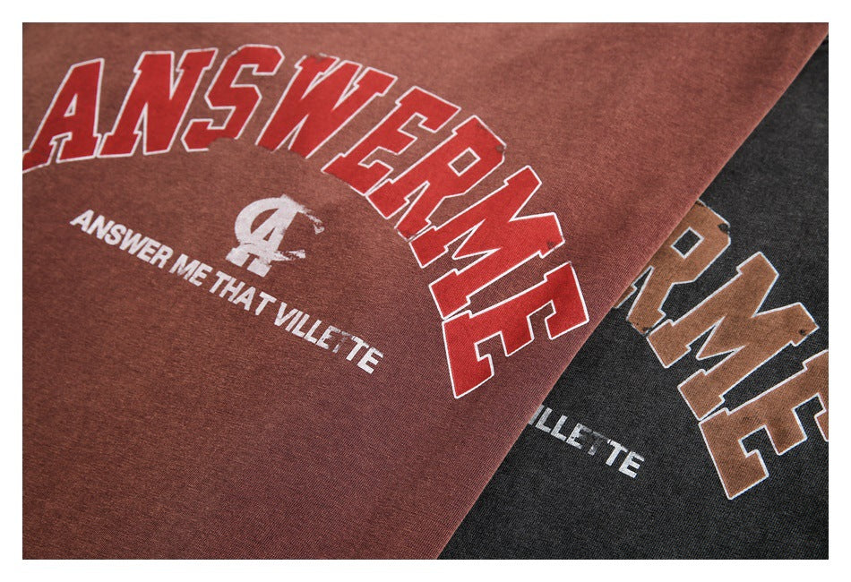 Close-up of rust-brown and charcoal sweatshirt fronts with large collegiate-style English graphic prints.