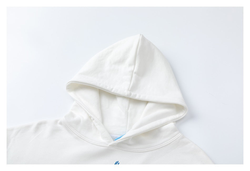 Close-up of the white hoodie’s hood and neckline against a pale background.