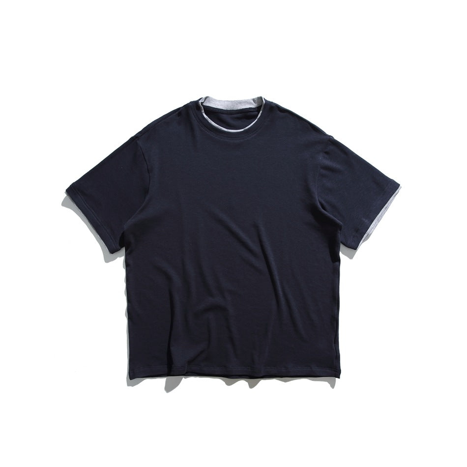 Navy short-sleeve crew-neck tee flat lay with gray layered trim at neckline and sleeve hems