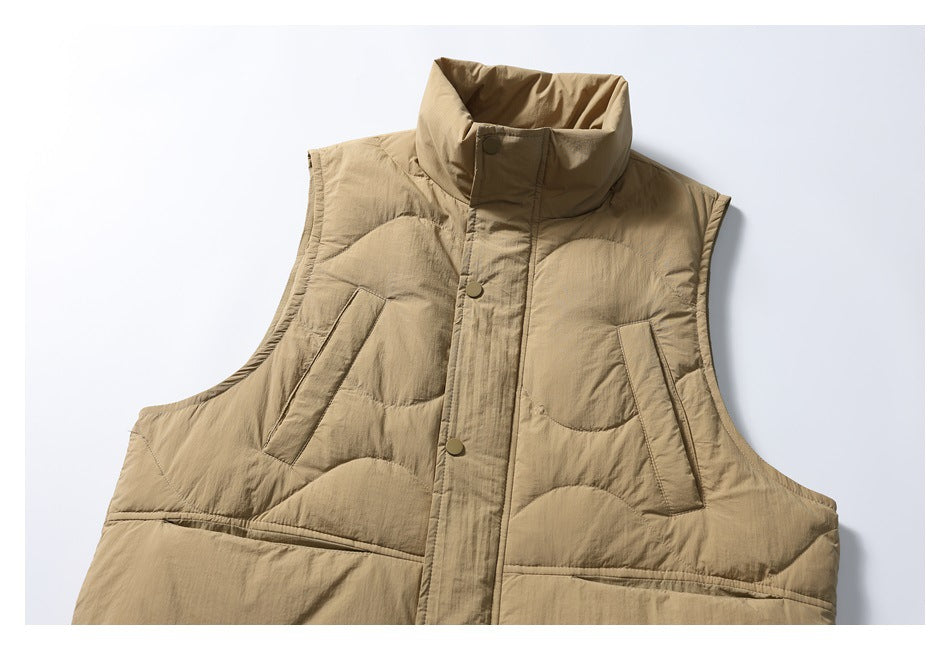Cropped front view of a tan quilted vest with a high collar, snap-front placket, and angled pockets.