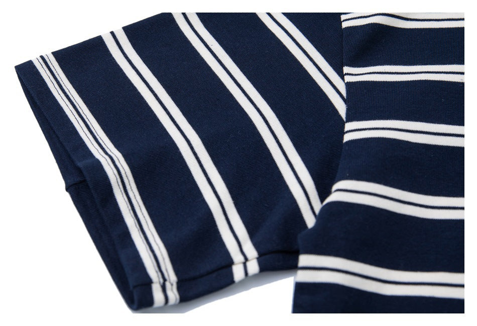 Close-up of folded navy fabric with narrow white stripes.