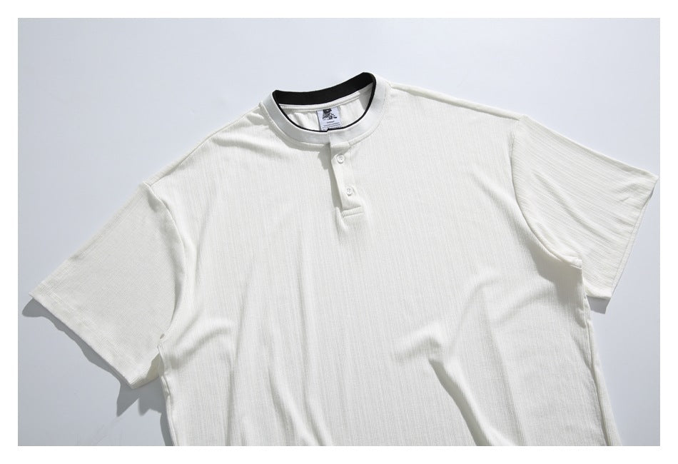 Front view of an off-white short-sleeve ribbed shirt with a band collar and two-button placket.