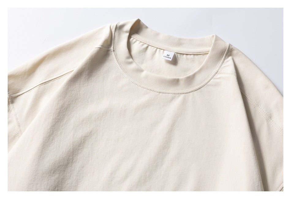 Cropped front view of a plain cream crewneck sweatshirt laid flat, with long sleeves and ribbed neckline.