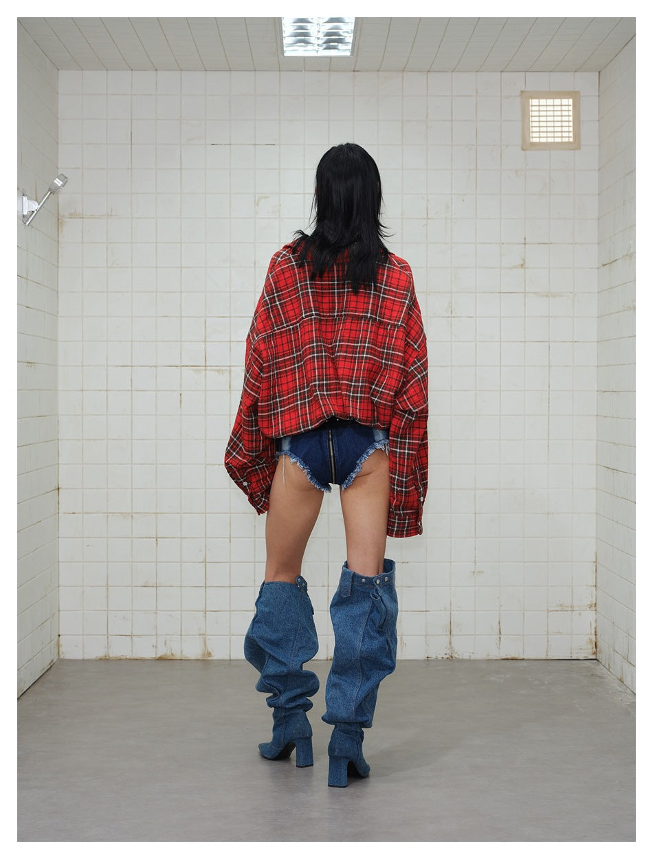 Back view of a model wearing a red plaid cropped shirt jacket with a back yoke seam and gathered hem