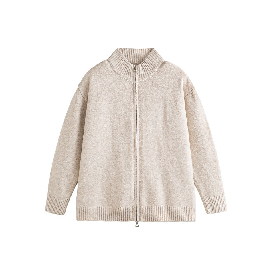 Apricot knit zip-up cardigan with ribbed stand collar, cuffs and hem, flat lay on white