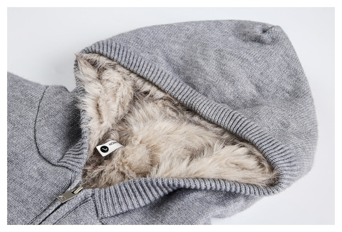 Close-up of a gray knit hooded jacket showing its ribbed hood edge, beige faux-fur lining, and zipper.