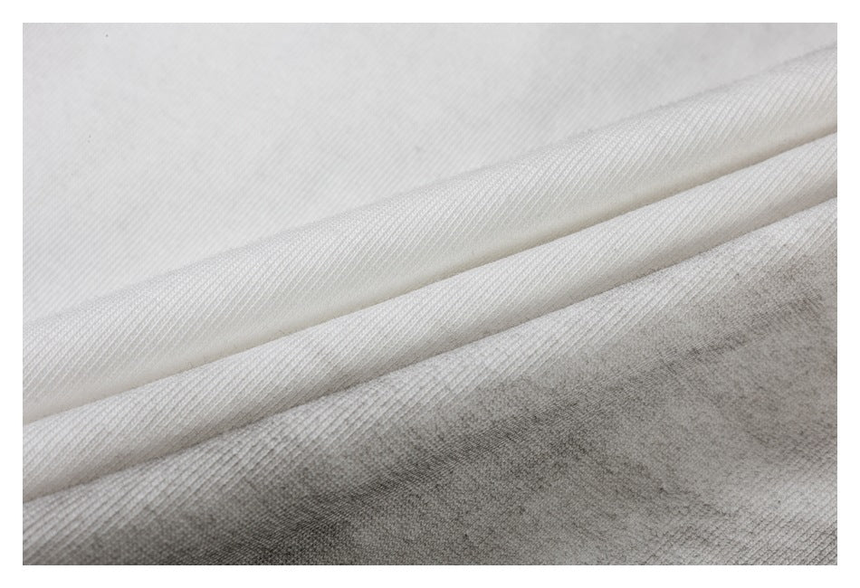 Close-up of folded white fabric showing its surface and knit texture.