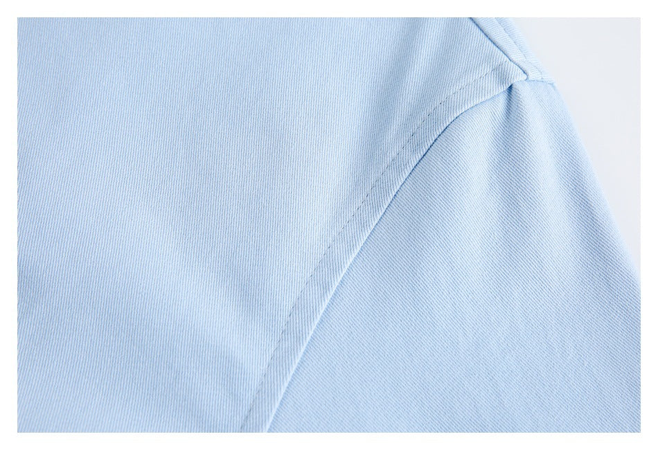 Close-up of a stitched seam on the light blue jacket.